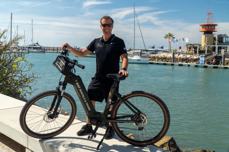 Man with electric bike rental at Vilamoura Marina Algarve Portugal